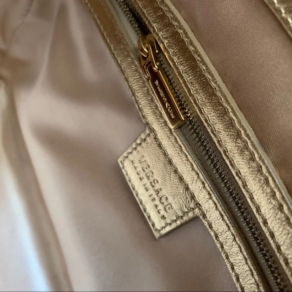 Hold Versace gold quilted handbag